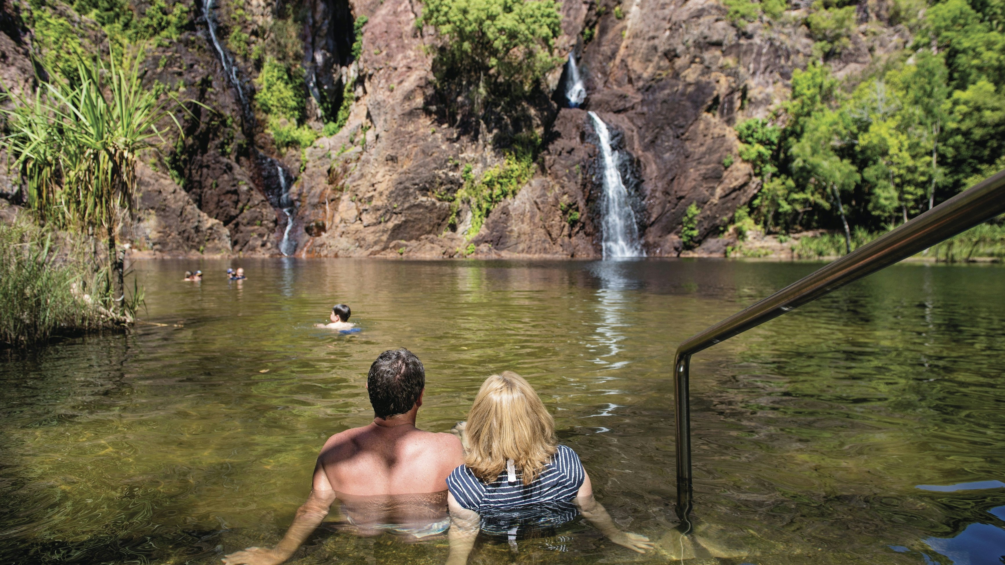A waterfall cascading into a natural plunge pool in Litchfield National Park, Northern Territory