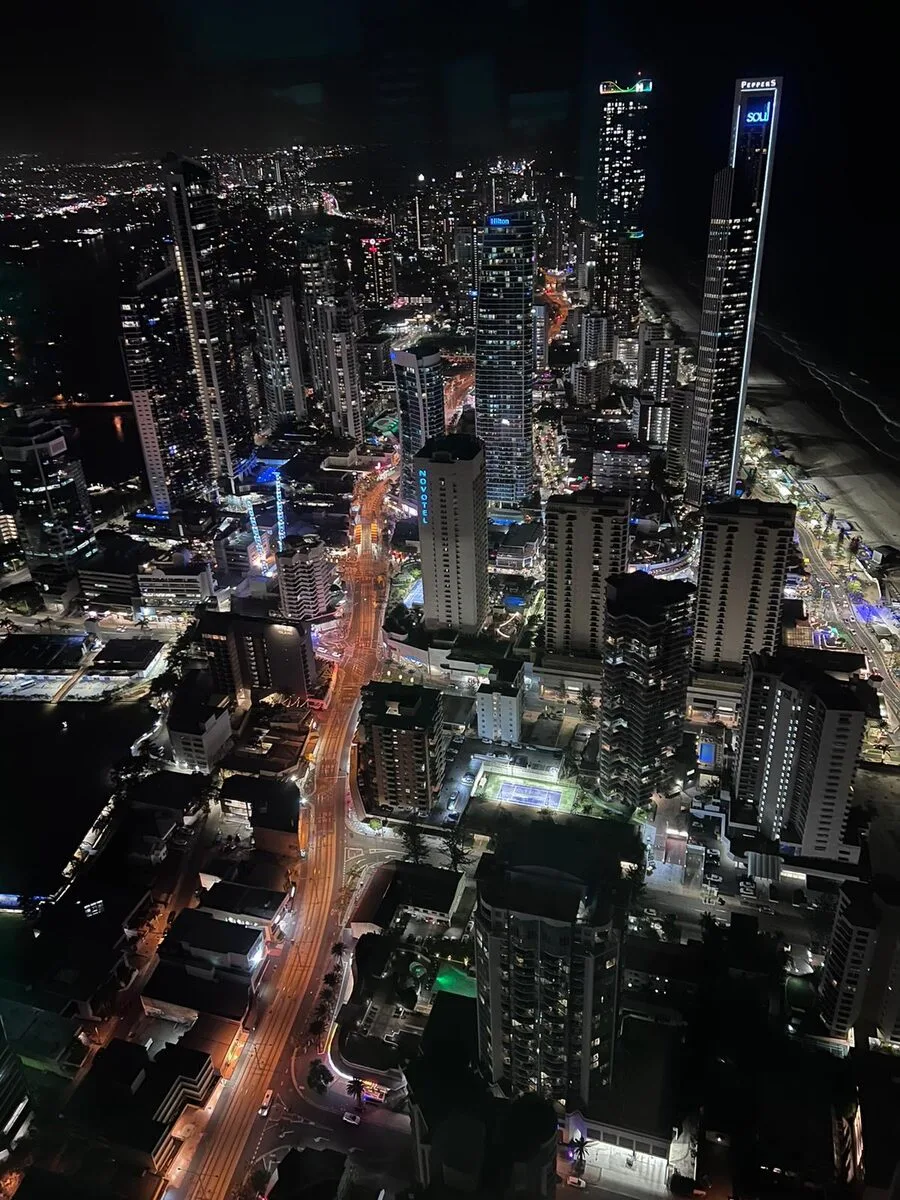 Aerial night view of the Gold Coast Surfers Paradise skyline lit up along the beach