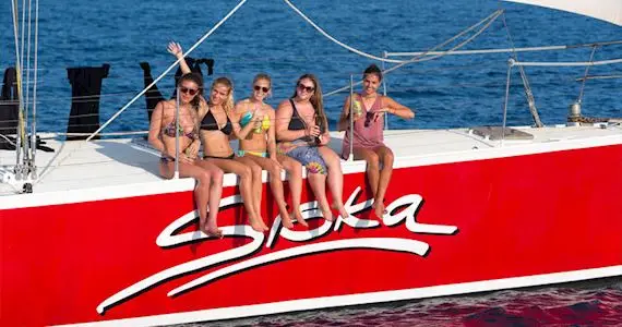 Travellers relaxing and socialising on deck during Siska Fun Sailing Whitsundays tour