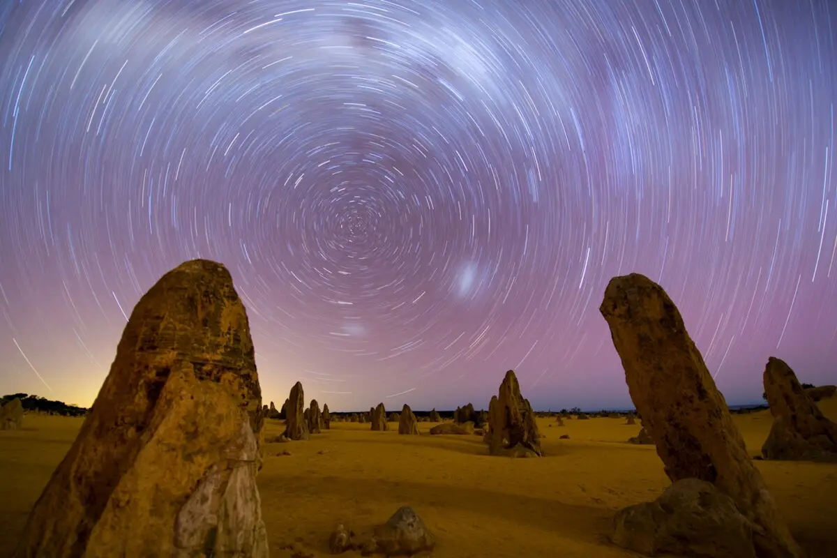 Travellers watching the sunset over the Pinnacles Desert during a guided tour from Perth