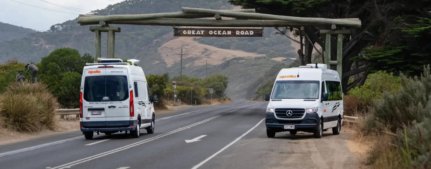 Apollo campervans driving under Great Ocean Road sign Victoria - campervan hire Melbourne