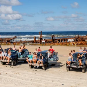 Group of travellers with 4WD vehicles at Maheno Shipwreck on Fraser Island