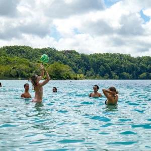 4WD convoy driving along wide sandy beach on Fraser Island coastline