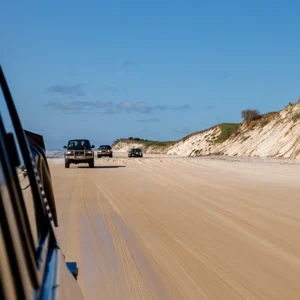 Group sitting on sand dunes watching sunset on Fraser Island