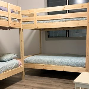 Shared hostel style bunk bed room used during Fraser Island camping tour