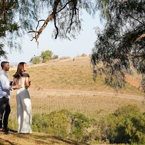 Couple enjoying wine at Bistro Molines with views across nearby Tallavera Grove Winery in Mount View.