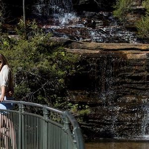 Couple enjoying a walk along the Wentworth Falls Track in the Blue Mountains National Park.