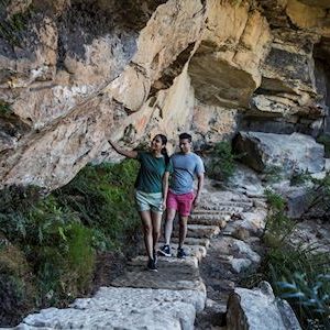 Couple enjoying a walk along the Wentworth Falls Track in the Blue Mountains National Park.