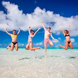 Dundee Adventure Travel | Whitsundays Private Charter Sailing through the Whitsunday Islands to the white silica sands of Whitehaven Beach is a popular activity in Australia. Friends play on the beach.