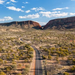 Long road through desert landscape in Central Australia