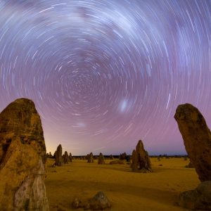 Travellers watching the sunset over the Pinnacles Desert during a guided tour from Perth