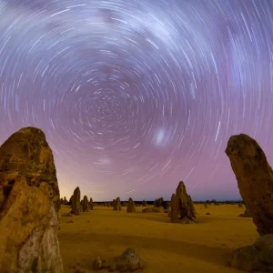 Travellers watching the sunset over the Pinnacles Desert during a guided tour from Perth