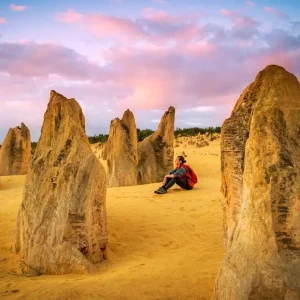ravellers watching the sunset over the Pinnacles Desert during a guided tour from Perth