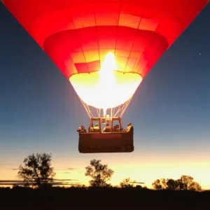 Hot air balloon inflating before sunrise