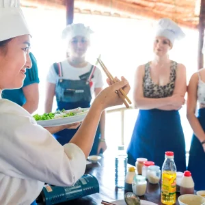 Travellers preparing Vietnamese food in cooking class