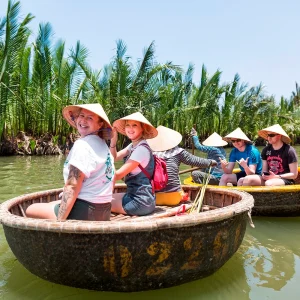 Vietnam Intro 12 days tour travellers riding traditional Vietnam basket boat in Hoi An