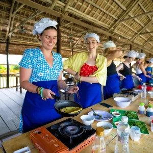 Vietnam Intro 12 days tour travellers learning Vietnamese cooking class